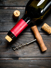 bottle of red wine with a corkscrew.