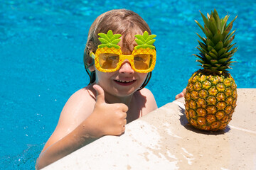 Child in swimming pool. Summer kids activity. Healthy lifestyle.