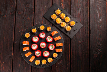 Rolls set with fish shrimp and caviar sushi with chopsticks - asian food and japanese cuisine concept top view