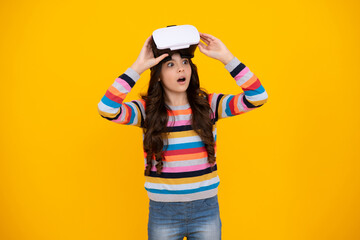 Excited teenager using VR headset. Girl play vr video game. Digital future and innovation. Child in virtual goggles. Excited teen girl with virtual reality goggles headset isolated on yellow.