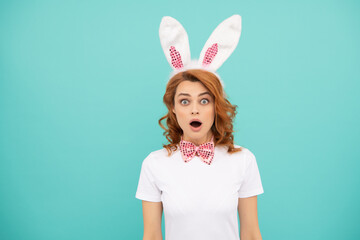 shocked easter woman with bunny ears on blue background