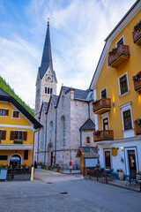 Fototapeta premium Austria, Hallstatt historical village. UNESCO world heritage site, old European architecture in sunlight. Hallstatter see in background. Hallstatt is iconic world landmark.