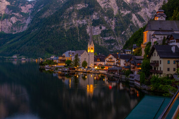 Fototapeta premium Austria, Hallstatt historical village. UNESCO world heritage site, old European architecture in sunlight. Hallstatter see in background. Hallstatt is iconic world landmark.