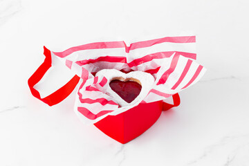 Heart shaped valentine's day cookies in red heart shaped box on white background
