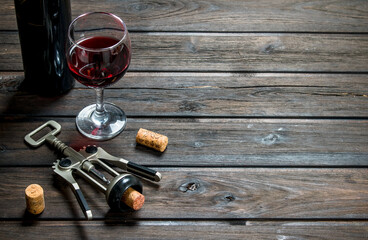 Wine background. Red wine with corkscrew.