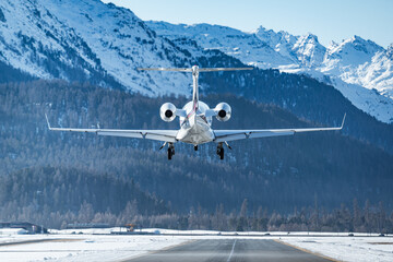 Luxurious business jet landing in the Swiss alps. Airplanes like this are the way to travel to the...