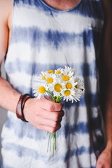 Bouquet of Wild Daisy Flowers in Male Hands
