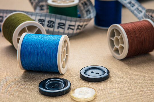 Top view of flat lay image showing garment and spool or sewing supplies 
