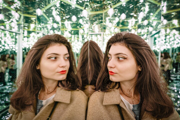 Young woman in mirror maze