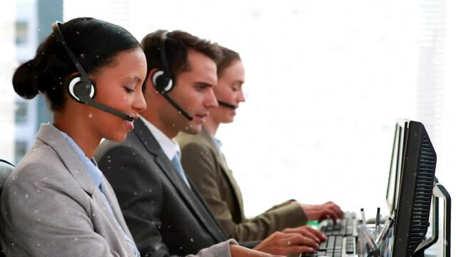 Animation of white particles over team of diverse customer care executives working at office