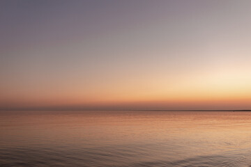 sunset sun by the ocean, clear water and sandy azure beach