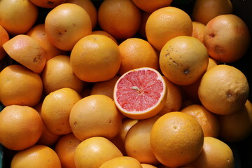 Sliced Red Blood Orange Citrus Standing Out Among Whole Oranges, Uniqueness concept