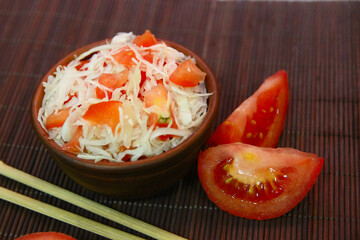 Tomatoes, lettuce and mackerel on a wooden table. 