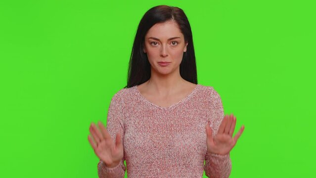 Hey you, be careful. Young woman warning with admonishing finger gesture, saying no, be careful, scolding and giving advice to avoid danger, disapproval sign. Girl isolated on chroma key background