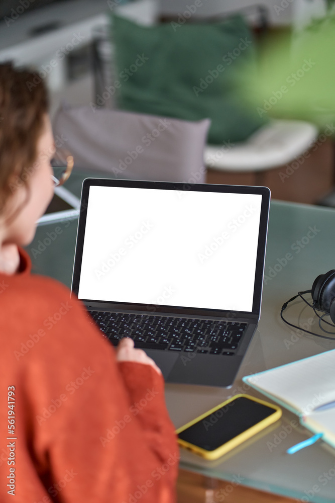 Wall mural over shoulder view of woman student elearning looking at white mock up blank screen using laptop com