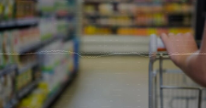 Animation of data processing against hand holding a shopping cart at a grocery store