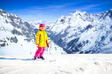 Fotobehang Kids winter snow sport. Children ski. Family skiing. © famveldman