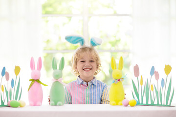 Kids on Easter egg hunt. Children dye eggs.