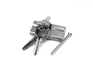 Pin tumbler of cylinder lock internal mechanism with keys on white background. New door lock with a bunch of keys on a white background.