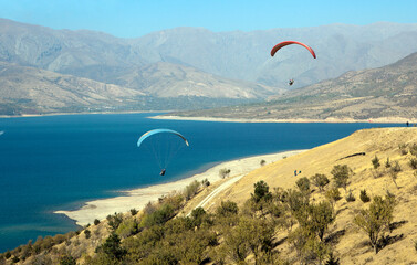 Paragliding over the Charvak reservoir. Bostanlyk region. Tashkent region. Uzbekistan