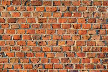 Red brick wall background, a beautiful architectural texture of an old clinker wall of an historic building