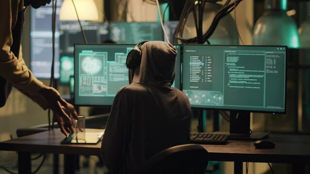 Female thief using her knowledge of network systems to access data and steal passwords. Criminal breaking security firewall for cyber espionage, hacktivism cryptojacking. Handheld shot.