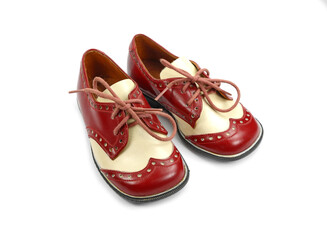 vintage red and white shoes for a little boy isolated on white.