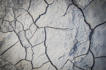 Cracked earth in the top view for the background or graphic design with the concept of drought and death.