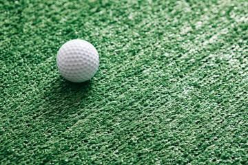 Golf BallOn Artificial Grass Background