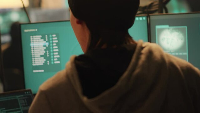 Cyber criminals working with dark web to do illegal hacktivism on online network, trying to steal information illegally. Team of people breaking into server for cyberwarfare. Handheld shot.