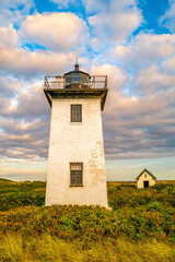 Fototapeta na wymiar Wood End Lighthouse in Provincetown on Cape Cod, Massachusetts, USA, oceanside beach seascape at golden sunset