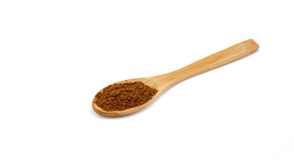 Pile of Garam Masala in a wooden spoon isolated on white background. Indian spice mix