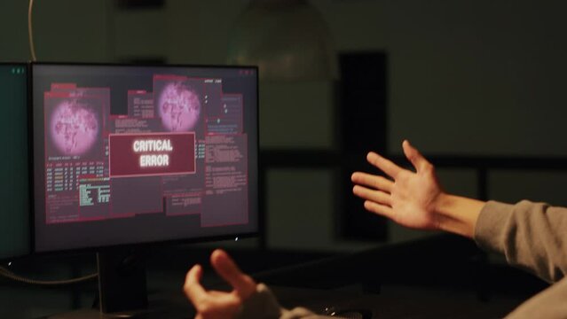 Happy criminal celebrating hacking success with data breach, attacking goverment system with encryption. Hacker committing identity and password theft, cryptojacking ransomware. Handheld shot.