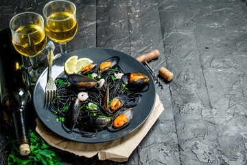Mediterranean food. Spaghetti with cuttlefish ink, clams and white wine.