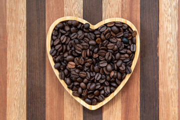 coffee beans in heart-shaped tra,y representing love of coffee