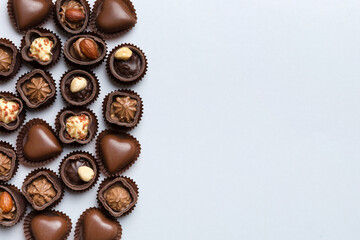 Different kinds of chocolates on colored table close-up. Top View and Flat Lay with copy space