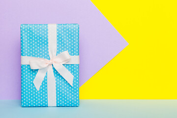 holiday handmade paper present tied white ribbon bow top view with copy space. Flat lay holiday background. Birthday or christmas present. Christmas gift box concept with copy space