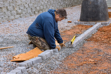 Pavers stone pathway paving master lays paving stones by using professional paver worker