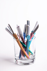 Set of multi-colored women's shaving razors in glass isolated on white background.