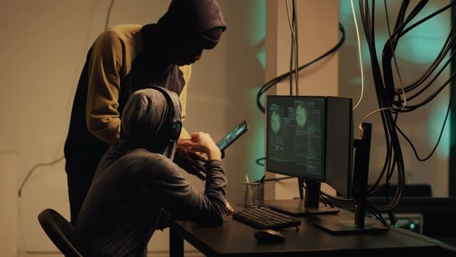 Woman hacker using her knowledge of computer systems to access information and steal passwords. Criminal breaking security firewall for espionage, hacktivism cryptojacking. Handheld shot.
