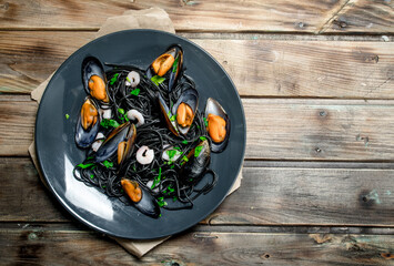 Mediterranean food. Spaghetti with cuttlefish black ink and clams.