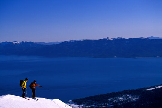Two men backcountry skiing above Lake Tahoe.