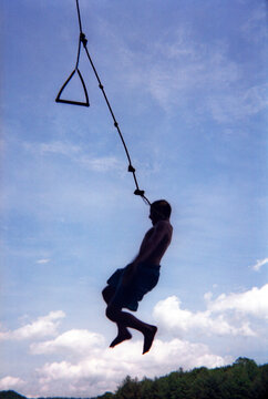 A boy drops from a rope swing into a lake in North Carolina.