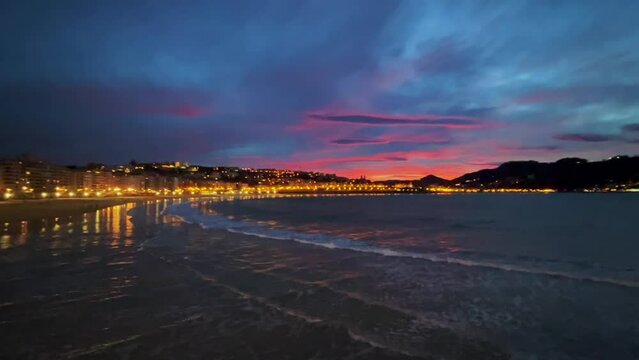 Beautiful colours sunset sky at La Contxa bay in San Sebastian, Spain