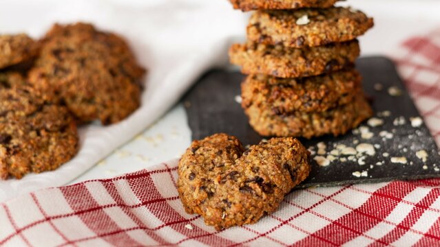 Homemade oatmeal and chocolate cookies in the shape of a heart on a wh