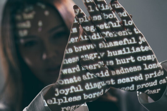 Projection: Woman Hiding Behind Hands With Emotions Shown On Them