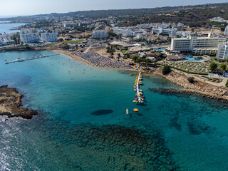 Fototapeta premium Aerial panoramic view on holidays resorts and blue crystal clear water on Mediterranean sea near Fig Tree beach, Protaras, Cyprus