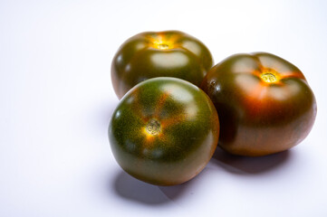 Fresh ripe sweet reddish brown and green kumato tomatoes