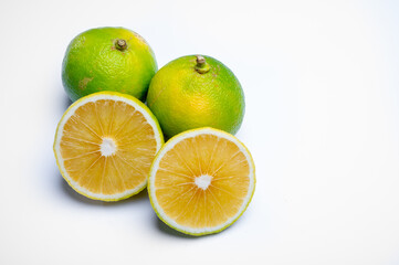 Fototapeta na wymiar Fresh ripe bergamot orange fruits, fragrant citrus used in earl grey tea, medicine and spa treatments on white background isolated