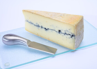 French semi-soft cow milk cheese morbier from Franche-Comte region with thin black layer and strong aroma